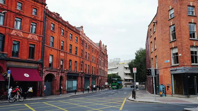A Dublin street with brick buildings and a bus